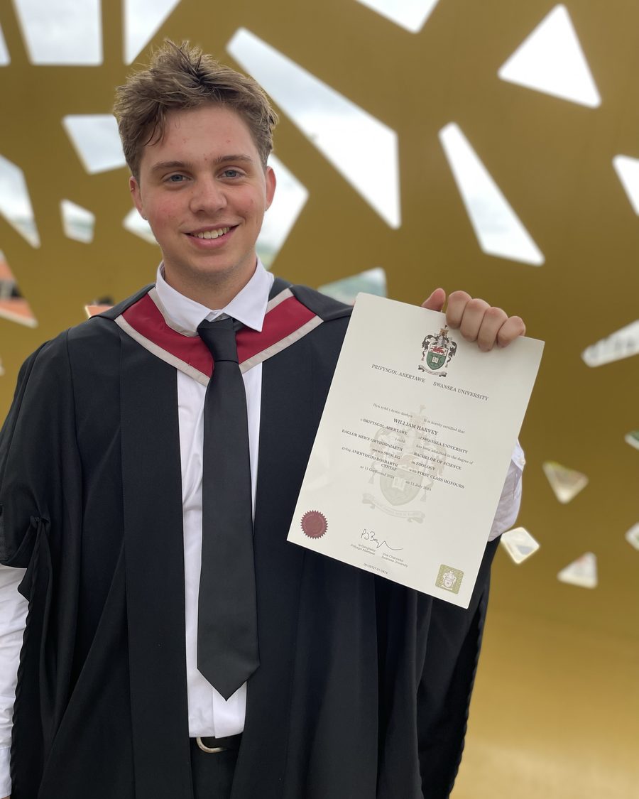 William Harvey holding his First Class Zoology degree certificate